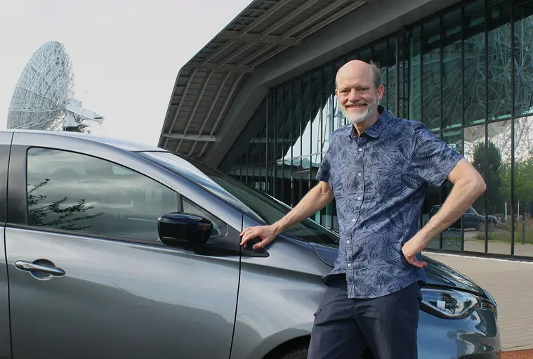 Gerhard Swart in front of building and car